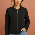 Women’s knitted cardigan in black with round neckline, soft and comfortable for casual and stylish outfits.